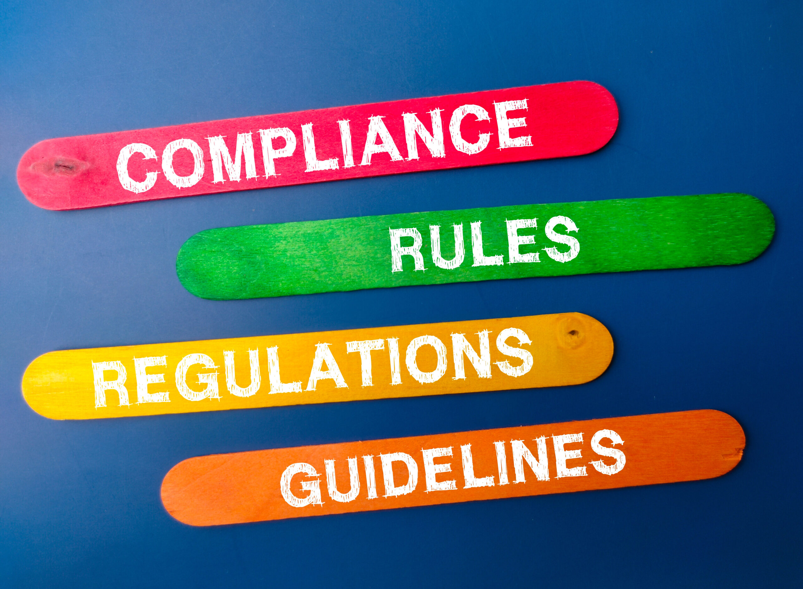 Colored ice cream stick with the word COMPLIANCE RULES REGULATIONS GUIDELINES. Business concept.