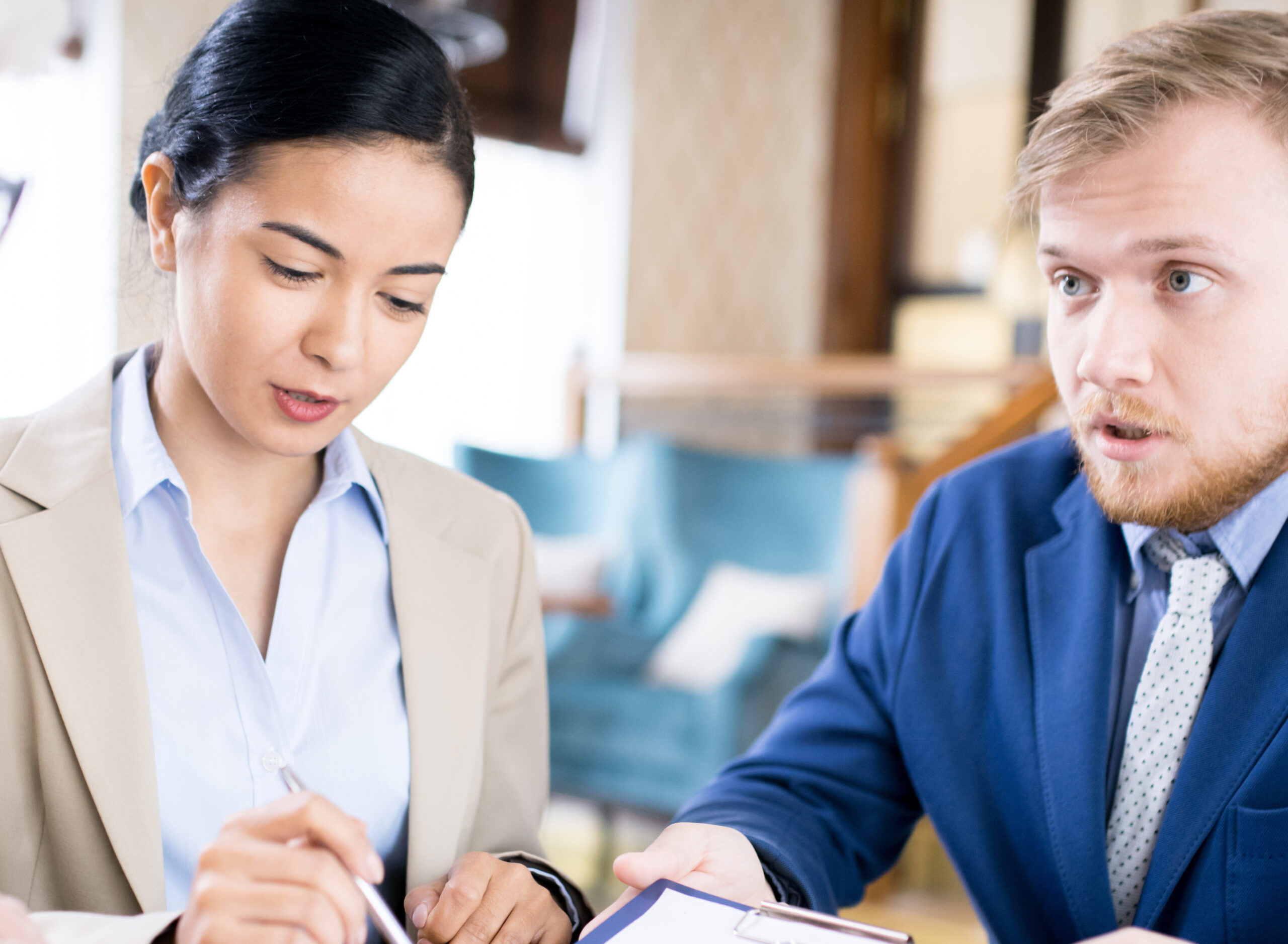 Two business agents explaining business contract to senior woman while sitting at cafe