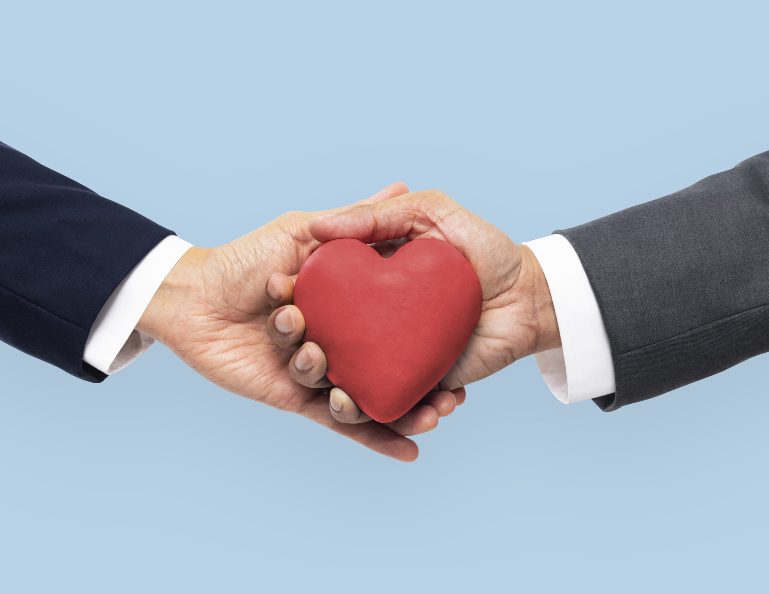Hands holding heart in love and relationship concept